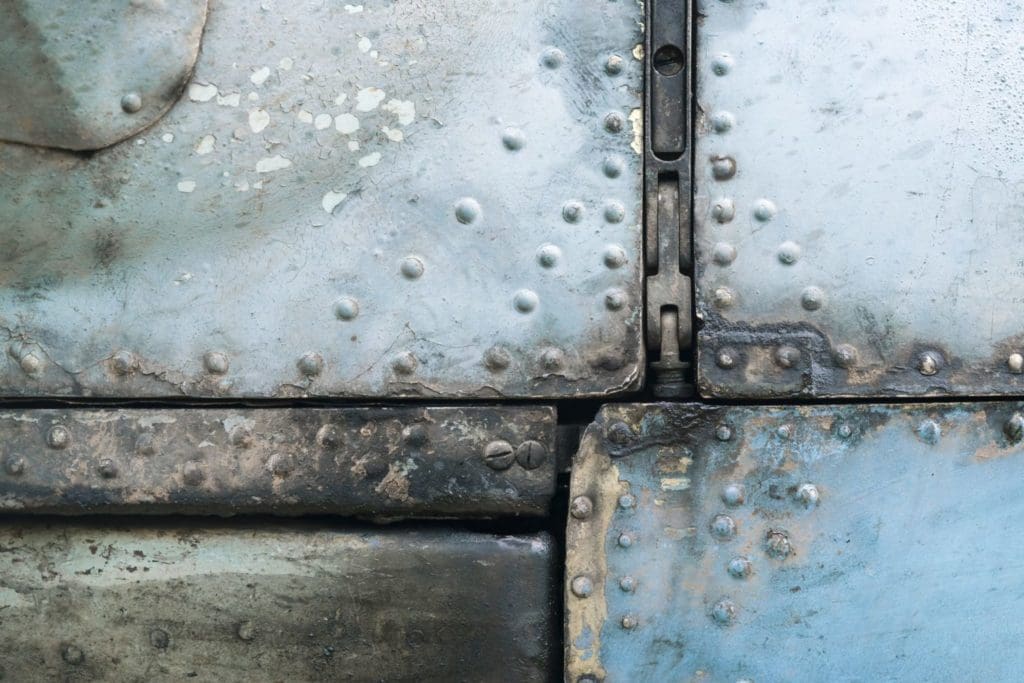 Close up of aircraft metal panels with corrosion