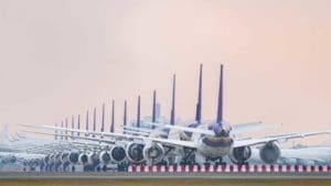 Fleet of commercial aircraft on an airport runway.